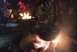 cooking over a campfire with a tripod