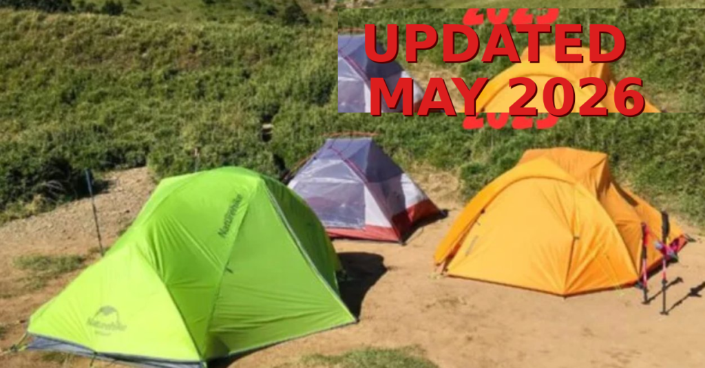 Three colorful tents pitched on a sandy campsite with green bushes in the background; bold red overlay text reads 'UPDATED MAY 2026'.